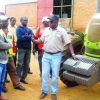 MARTIN-Sikanyika-right-explaining-to-Conservation-Farming-Unit-field-officers-on-tractor-990×651