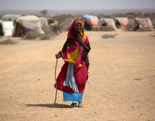An old woman walks in a camp for internally displaced people in Uusgure village Puntland Somalia 5 Feb 2017. Credit FAO Karel Prinsloo