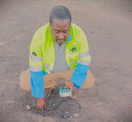 Charles Odhiambo operating a digital sol testing kit 123