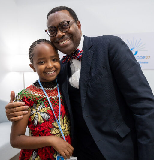 African Development Bank Group President Akinwumi Adesina congratulates young Karen Kimani for her passion for protecting the environment during COP27 in Egypt in November 2022