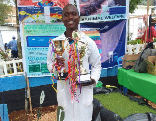 Policarp with some of the trophies he has won